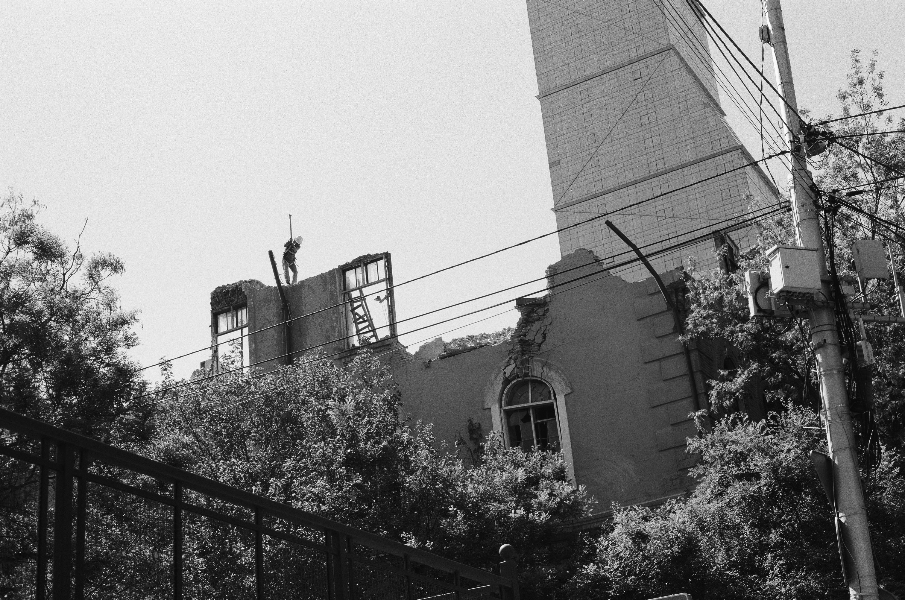 grayscale photo of building near trees